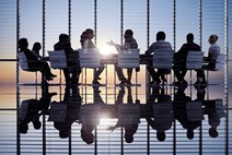 Business professionals around a table for a meeting