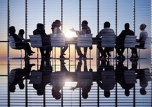 Business professionals around a table for a meeting