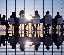 Business professionals around a table for a meeting