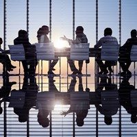 Business professionals around a table for a meeting