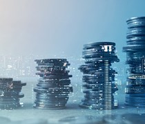 Coins piling up double exposed with cityscape