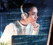 Student studying with headphones at a computer