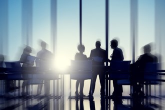 Business professionals at a meeting by a large window