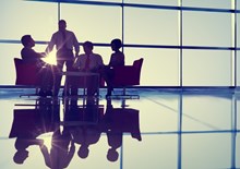 Business professionals at a meeting by a large window