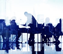 Business professionals at a meeting by a large window