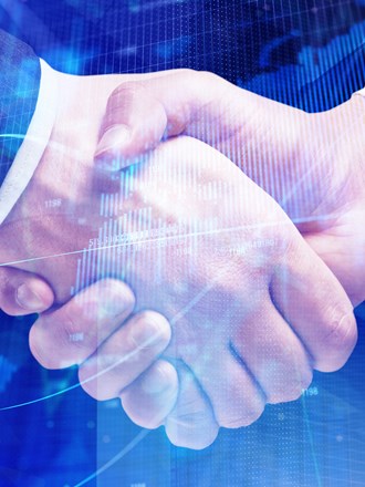 Digital map superimposed with two men shaking hands