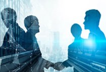 Silhouettes of people shaking hands