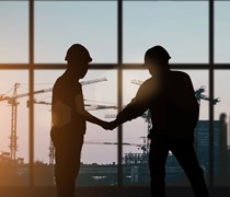 Two builders shaking hands