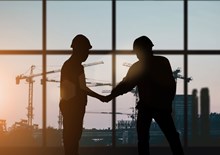 Two builders shaking hands
