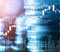 Stacks of coins and financial charts
