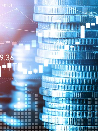Stacks of coins and financial charts