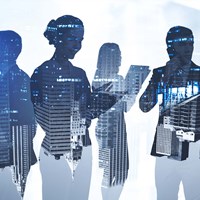 Business professionals superimposed on a cityscape
