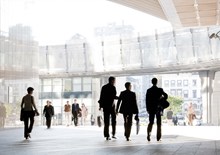 Business professionals walking around modern office space