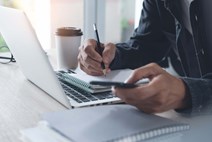 Person with laptop and notepad