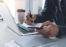 Person with laptop and notepad