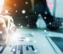 Businessman drawing on financial charts