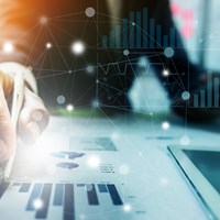 Businessman drawing on financial charts