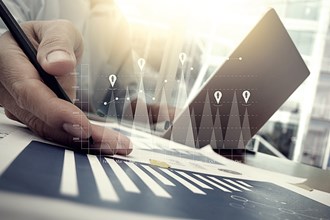 Businessman using laptop with financial charts