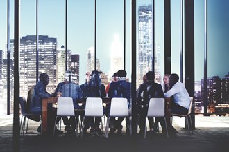 Business professionals at a meeting by a large window