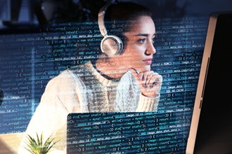 Student studying with headphones at a computer