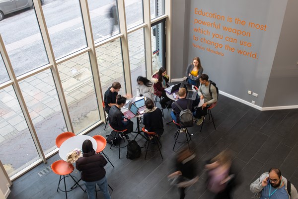 Birds eye view of students studying together in communal area