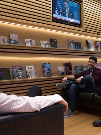 Group of students socialising and relaxing on sofas