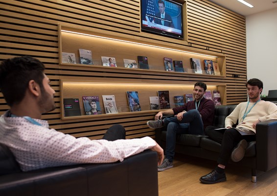 Group of students socialising and relaxing on sofas