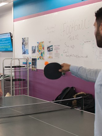 Two students playing table tennis