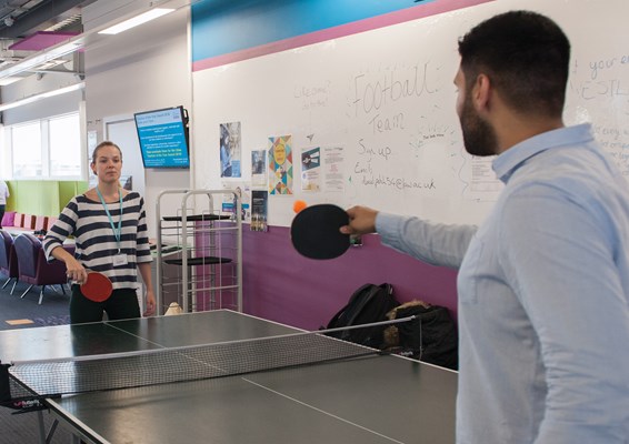 Two students playing table tennis