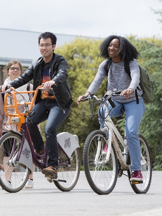 Students cycling through Reading University campus Students cycling through Reading University campus