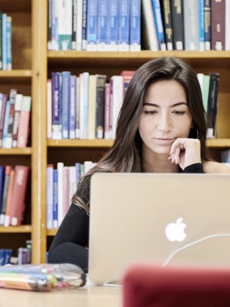 Female student studying in library Female student studying in library