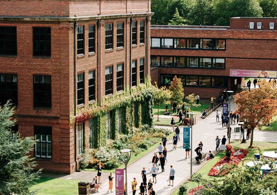 Students walking around the sunny campus of Hull University