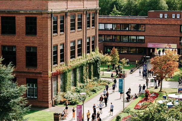 Students walking around the sunny campus of Hull University