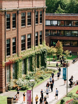 Students walking around the sunny campus of Hull University
