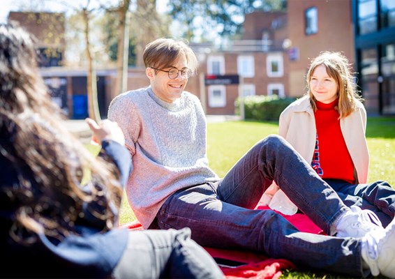 Group of students at Leicester campus sitting outside