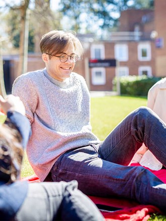 Group of students at Leicester campus sitting outside