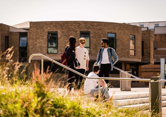 Group of students socialising outside at Lancaster campus