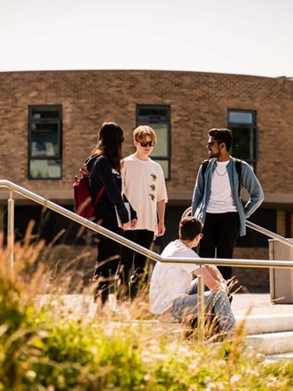 Group of students socialising outside at Lancaster campus