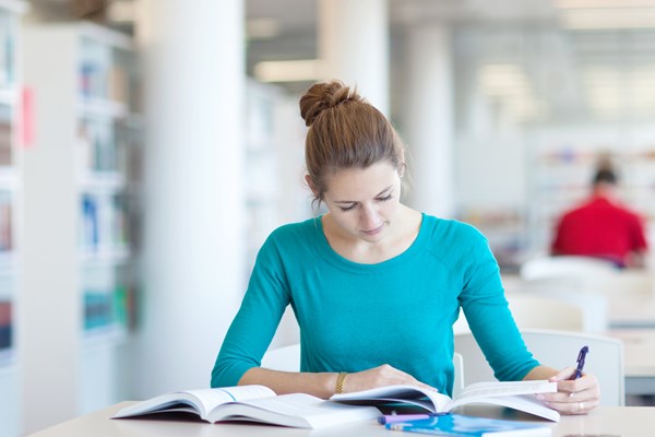 Student studying in library area Student studying in library area