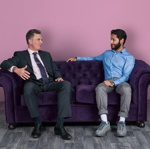 Mentoring Student and teacher talking on sofa
