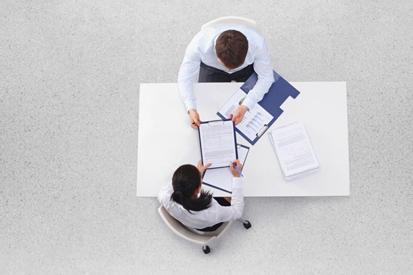Overhead view of man and woman in meeting Overhead view of