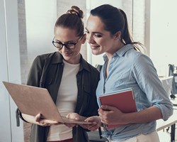 Two business women looking at laptop