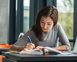 Woman sitting at desk studying 