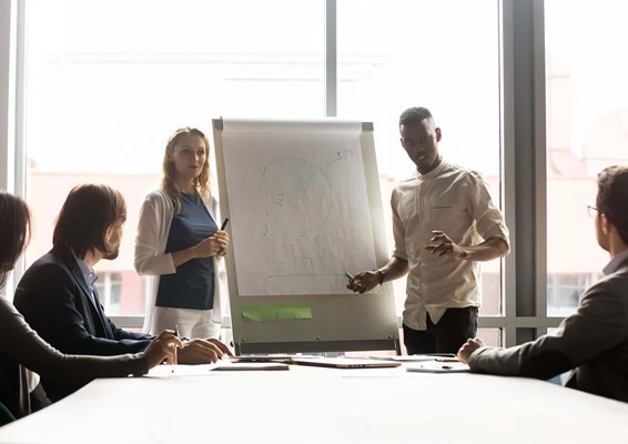 Students presenting in boardroom