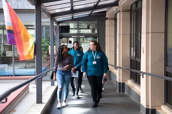 A group of students walking with support staff