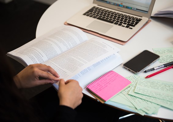 Close up of a student studying from a law book Close up of a student studying from a law book