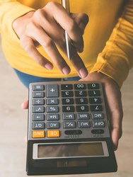 Person using a calculator Person using a calculator