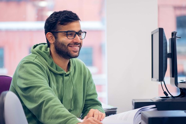 Smiling student working on a computer