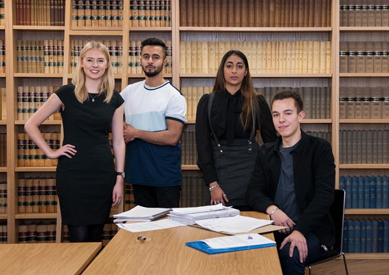 Students infront of bookshelves