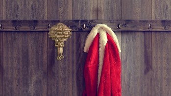 Santas coat and barrister wig on clothes hooks